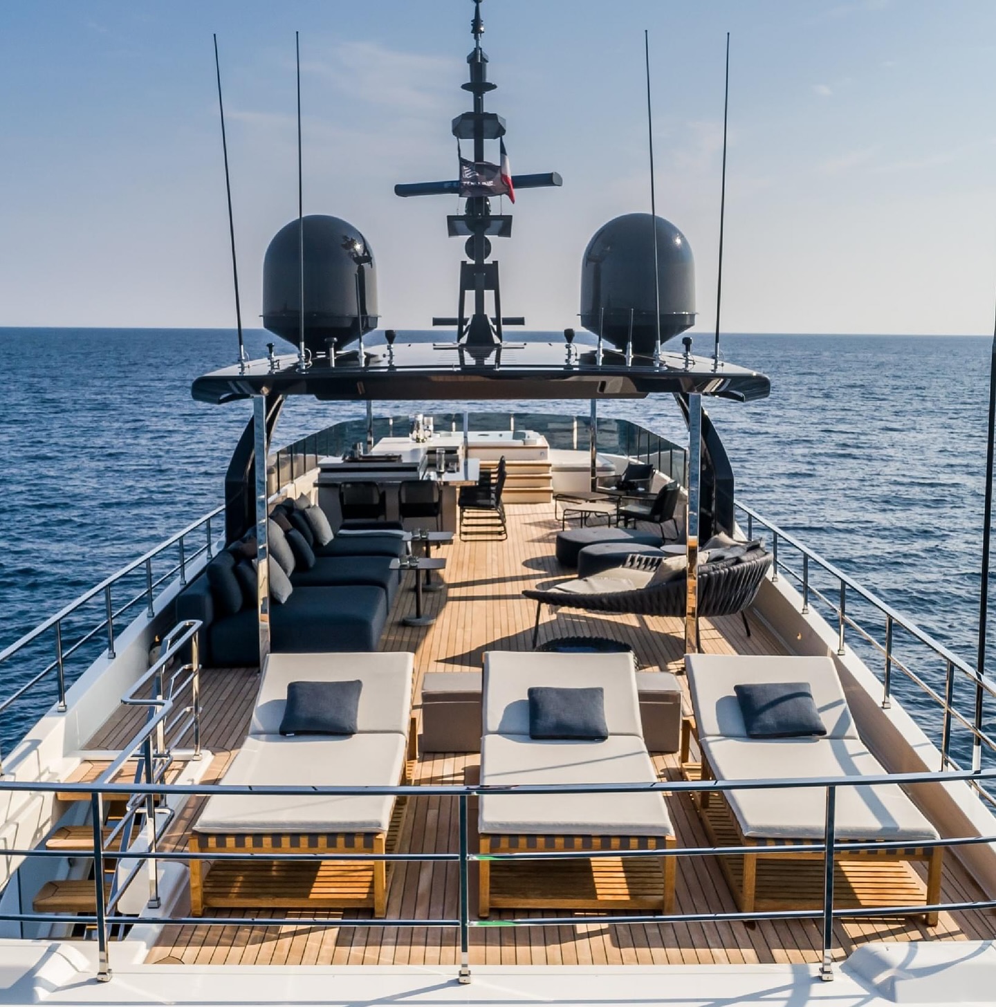 Group of people relaxing on a luxury yacht deck during sunset
